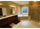 Bathroom with dual sink vanity, soaking tub, and glass shower enclosure at 1520 Vassar Ave, College Park, GA 30337