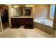 Bathroom with double vanity, tile floor, jacuzzi tub, and walk in closet at 1520 Vassar Ave, College Park, GA 30337