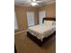 Neutral colored bedroom with carpeted floors, three windows, and a ceiling fan at 1520 Vassar Ave, College Park, GA 30337