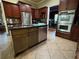Eat in kitchen with a kitchen island, stainless steel appliances, and tile flooring at 1520 Vassar Ave, College Park, GA 30337