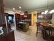 Open concept kitchen with island, granite counters, custom cabinets, stainless appliances and breakfast nook at 1520 Vassar Ave, College Park, GA 30337