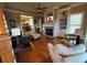 Comfortable living room with fireplace, wood floors, built-in shelving, and a view to kitchen at 1520 Vassar Ave, College Park, GA 30337