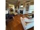 Living room featuring wood floors, fireplace, built-in shelves, and large windows for natural light at 1520 Vassar Ave, College Park, GA 30337
