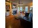 Bright living room featuring wood floors, fireplace, and built-in shelving with natural light from the windows at 1520 Vassar Ave, College Park, GA 30337