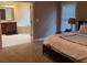 Bedroom leading to the bathroom with tile flooring, jacuzzi tub, and wood cabinets at 1520 Vassar Ave, College Park, GA 30337