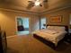 Spacious main bedroom featuring neutral tones, tray ceilings, and ensuite bathroom at 1520 Vassar Ave, College Park, GA 30337