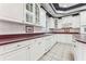 Kitchen with white cabinets, granite countertops, and tile floors at 4265 Eddie Byrd Ln, Loganville, GA 30052