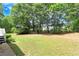 Spacious backyard with mature trees and grassy area at 114 Tracy Ln, Mcdonough, GA 30253