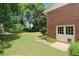 Landscaped backyard with a spacious lawn and storage building at 114 Tracy Ln, Mcdonough, GA 30253