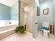 Bathroom with a shower, toilet and a large plant at 114 Tracy Ln, Mcdonough, GA 30253