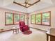 Spacious bedroom with large windows, hardwood floors, and a red recliner at 114 Tracy Ln, Mcdonough, GA 30253