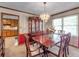 Bright dining room features a wood table and hutch, chandelier, and view of kitchen at 114 Tracy Ln, Mcdonough, GA 30253