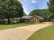 Brick ranch home with a long paved driveway at 114 Tracy Ln, Mcdonough, GA 30253