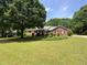 Brick ranch home with a large green lawn at 114 Tracy Ln, Mcdonough, GA 30253