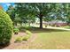 Landscaped front yard with lush greenery and trees at 114 Tracy Ln, Mcdonough, GA 30253