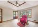 Bright Gathering room with a ceiling fan and a comfortable red recliner at 114 Tracy Ln, Mcdonough, GA 30253