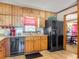 Kitchen with wood cabinets, granite counters, and a view into dining room at 114 Tracy Ln, Mcdonough, GA 30253