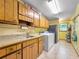 Laundry room with wood cabinets, a sink, and a washer and dryer at 114 Tracy Ln, Mcdonough, GA 30253