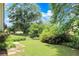 Landscaped side yard with stone path and lush plants at 114 Tracy Ln, Mcdonough, GA 30253