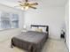 Bright bedroom featuring a gray bedding set and ceiling fan at 3007 Winding Sw Way, Lilburn, GA 30047