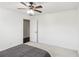 Bedroom with gray bedding and ceiling fan, door to another room at 3007 Winding Sw Way, Lilburn, GA 30047