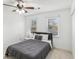 Bedroom with gray bedding and ceiling fan, two windows at 3007 Winding Sw Way, Lilburn, GA 30047