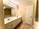 Double vanity bathroom with a large mirror and a soaking tub at 307 Creek Manor Way, Suwanee, GA 30024