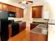 Open kitchen with granite countertops and a breakfast bar at 307 Creek Manor Way, Suwanee, GA 30024