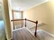 View of a carpeted staircase with wooden railings leading to the upper level at 307 Creek Manor Way, Suwanee, GA 30024