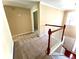 Upstairs hallway with carpet and access to bedrooms at 307 Creek Manor Way, Suwanee, GA 30024