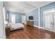 Main bedroom with hardwood floors, light blue walls, and a large bed at 3998 St Georges Ct, Duluth, GA 30096