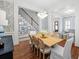 Bright dining room with hardwood floors, large table, and stylish light fixture at 3998 St Georges Ct, Duluth, GA 30096