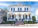 Two-story white brick home with black shutters, a large front porch, and a brick walkway at 3998 St Georges Ct, Duluth, GA 30096