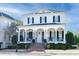 Two-story white brick home with black shutters, a large front porch, and a brick walkway at 3998 St Georges Ct, Duluth, GA 30096