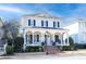 Two-story white brick home with black shutters, a large front porch, and a brick walkway at 3998 St Georges Ct, Duluth, GA 30096