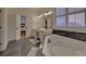 Elegant bathroom with double vanity, soaking tub, and marble floors at 6320 Glen Oaks Ln, Sandy Springs, GA 30328