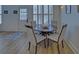 Bright dining room features a round table with four chairs, hardwood floors and a view to the back yard at 6320 Glen Oaks Ln, Sandy Springs, GA 30328