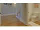 Light and bright hallway with hardwood floors and powder room at 6320 Glen Oaks Ln, Sandy Springs, GA 30328