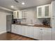 Modern basement kitchenette with white cabinets and wood countertop at 820 Oak Ter, Norcross, GA 30071