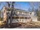 Two-story house with gray siding, white porch, and a two-car garage at 820 Oak Ter, Norcross, GA 30071