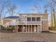 Back exterior view showing deck, screened porch and wooded setting at 820 Oak Ter, Norcross, GA 30071