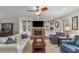 Cozy living room featuring a brick fireplace, built-in shelving, and hardwood floors at 820 Oak Ter, Norcross, GA 30071