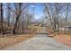 House nestled in a wooded area with a long driveway at 15 Indian Woods Ne Dr, Rydal, GA 30171