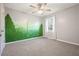 Bedroom with forest mural and ceiling fan at 15 Indian Woods Ne Dr, Rydal, GA 30171