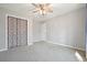 Spacious bedroom with ceiling fan and closet at 15 Indian Woods Ne Dr, Rydal, GA 30171