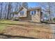 Tan house with white shutters, a wooden deck, and a landscaped yard at 15 Indian Woods Ne Dr, Rydal, GA 30171