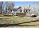 Tan house with white shutters, a wooden deck, and a grassy yard at 15 Indian Woods Ne Dr, Rydal, GA 30171