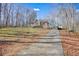 Tan house with white shutters, a wooden deck, and a long driveway at 15 Indian Woods Ne Dr, Rydal, GA 30171