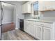 White cabinets and gray countertops highlight this updated kitchen at 15 Indian Woods Ne Dr, Rydal, GA 30171