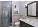 Modern bathroom with glass shower and dark vanity at 2465 Henderson Rd, Tucker, GA 30084